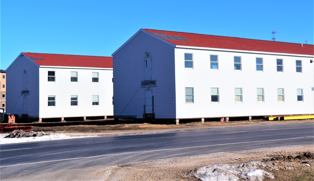 Contractors moving four World War II-era barracks buildings at Fort McCoy