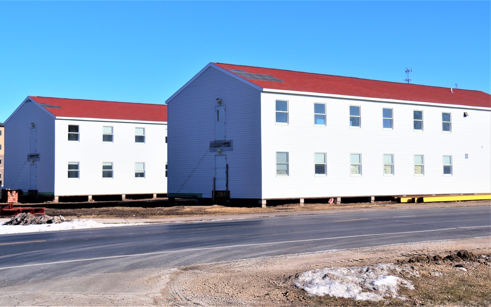 Contractors moving four World War II-era barracks buildings at Fort McCoy