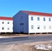 Contractors moving four World War II-era barracks buildings at Fort McCoy