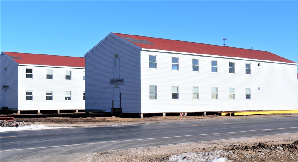 Contractors moving four World War II-era barracks buildings at Fort McCoy