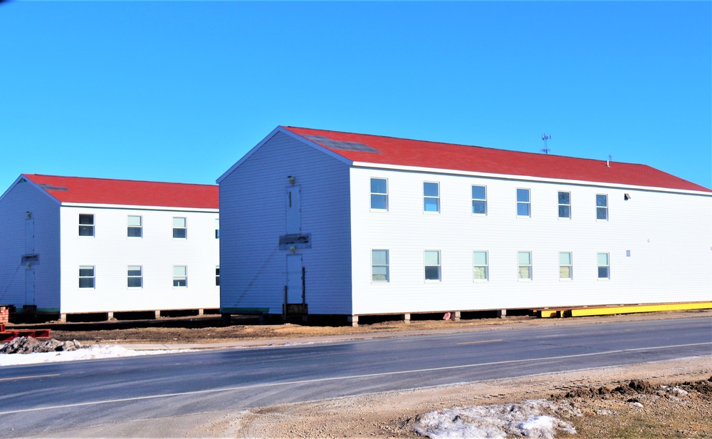 Contractors moving four World War II-era barracks buildings at Fort McCoy