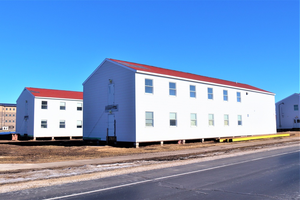 Contractors moving four World War II-era barracks buildings at Fort McCoy