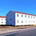 Contractors moving four World War II-era barracks buildings at Fort McCoy