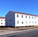 Contractors moving four World War II-era barracks buildings at Fort McCoy