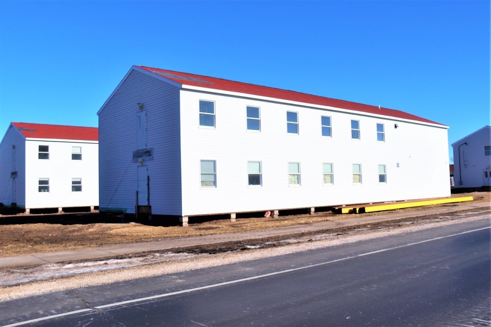 Contractors moving four World War II-era barracks buildings at Fort McCoy