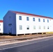 Contractors moving four World War II-era barracks buildings at Fort McCoy