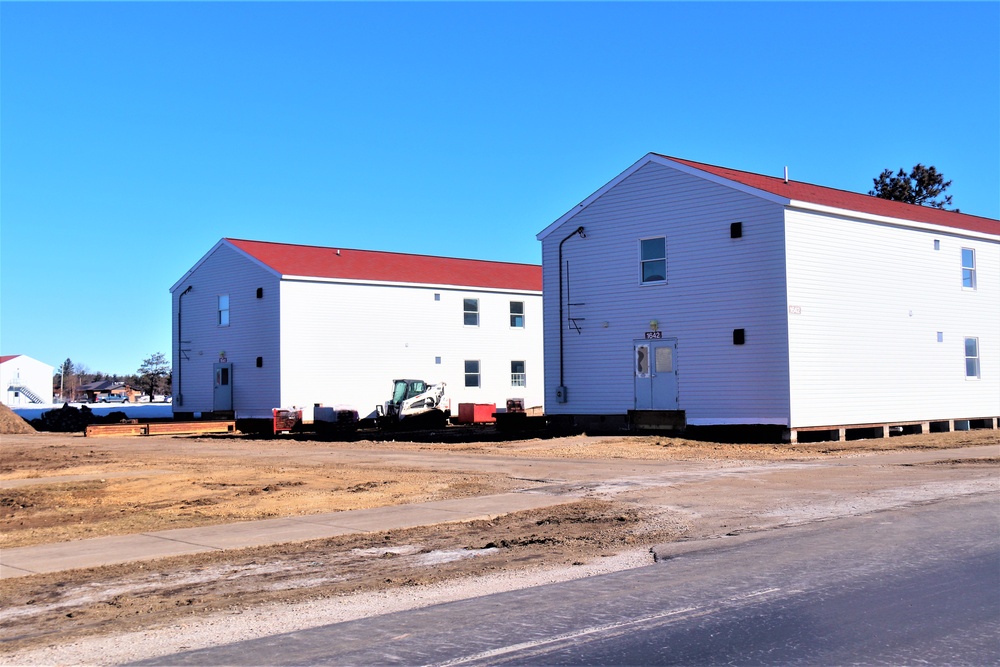 Contractors moving four World War II-era barracks buildings at Fort McCoy