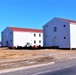 Contractors moving four World War II-era barracks buildings at Fort McCoy