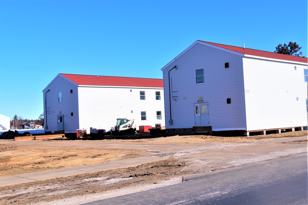 Contractors moving four World War II-era barracks buildings at Fort McCoy