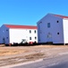 Contractors moving four World War II-era barracks buildings at Fort McCoy