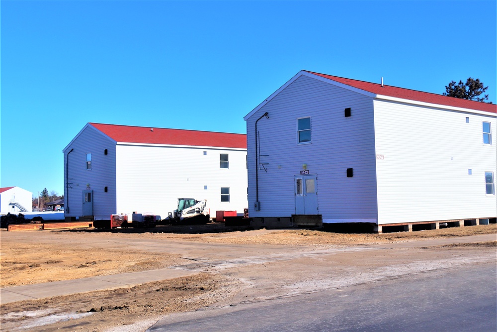 Contractors moving four World War II-era barracks buildings at Fort McCoy