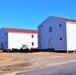 Contractors moving four World War II-era barracks buildings at Fort McCoy