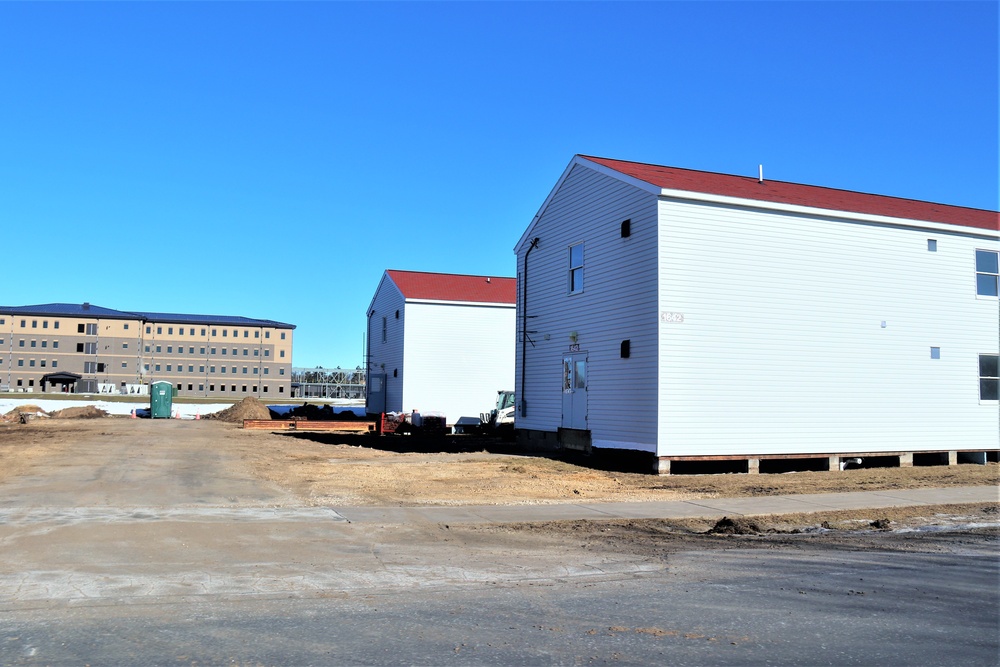 Contractors moving four World War II-era barracks buildings at Fort McCoy