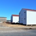 Contractors moving four World War II-era barracks buildings at Fort McCoy