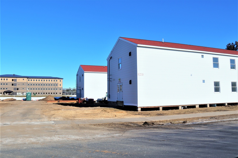 Contractors moving four World War II-era barracks buildings at Fort McCoy