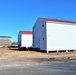 Contractors moving four World War II-era barracks buildings at Fort McCoy