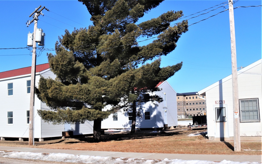 Contractors moving four World War II-era barracks buildings at Fort McCoy