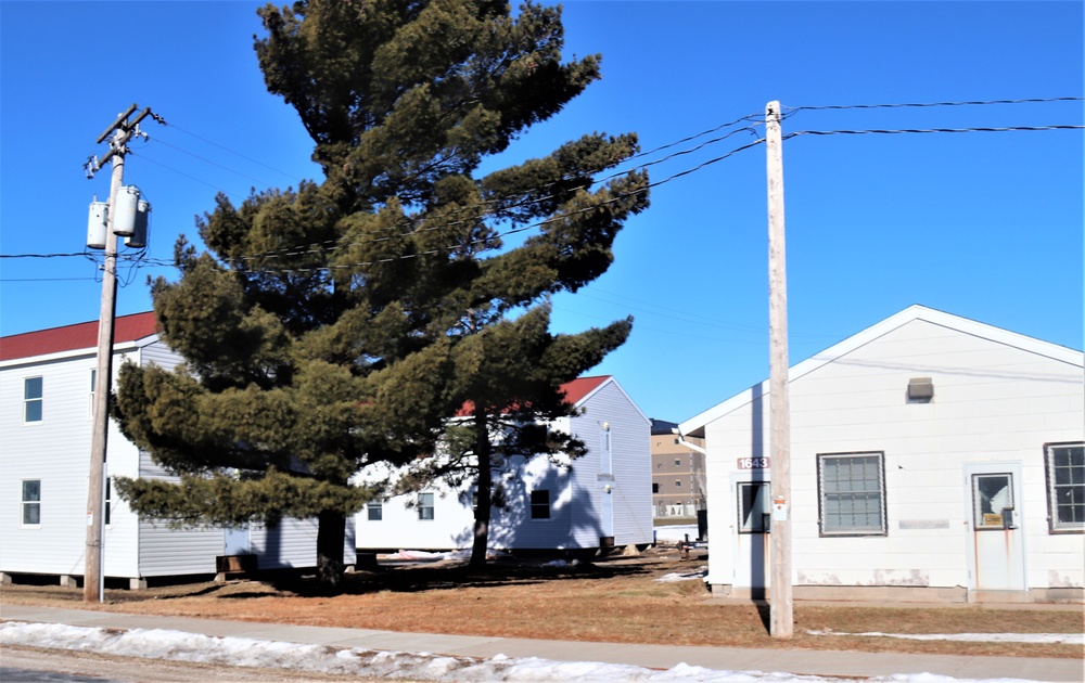 Contractors moving four World War II-era barracks buildings at Fort McCoy