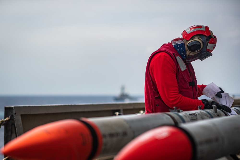 Sailor Inspects Ordnance