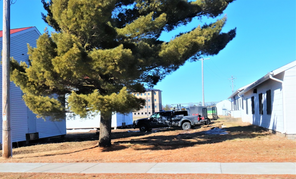 Contractors moving four World War II-era barracks buildings at Fort McCoy