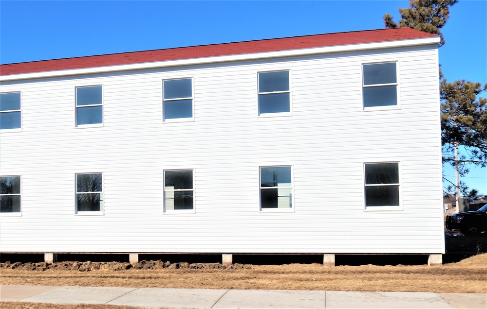 Contractors moving four World War II-era barracks buildings at Fort McCoy