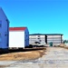 Contractors moving four World War II-era barracks buildings at Fort McCoy