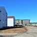 Contractors moving four World War II-era barracks buildings at Fort McCoy