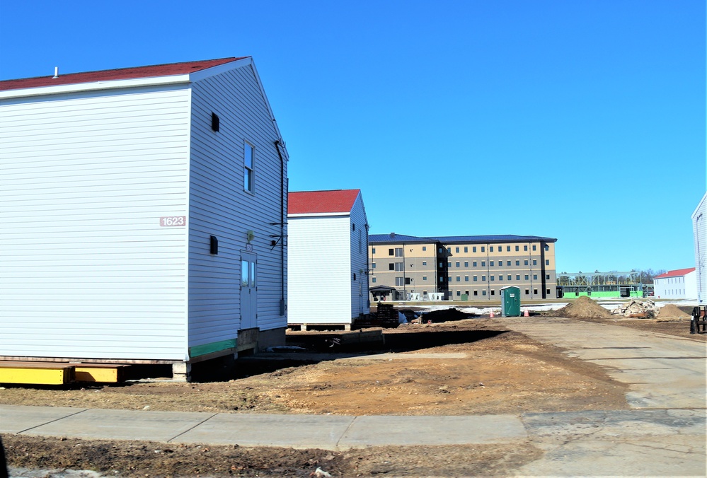 Contractors moving four World War II-era barracks buildings at Fort McCoy