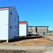 Contractors moving four World War II-era barracks buildings at Fort McCoy