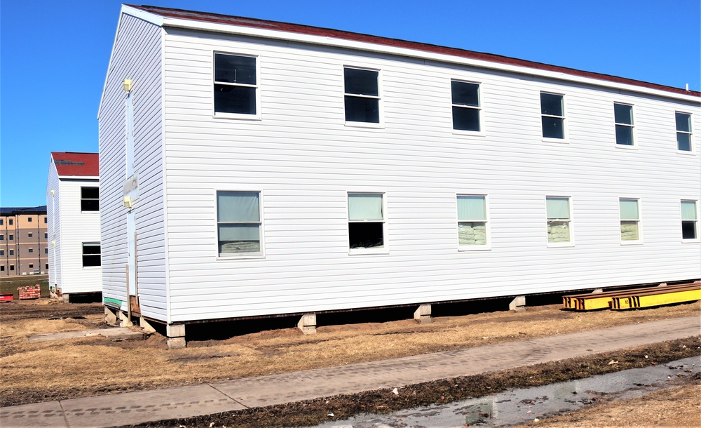 Contractors moving four World War II-era barracks buildings at Fort McCoy