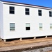 Contractors moving four World War II-era barracks buildings at Fort McCoy