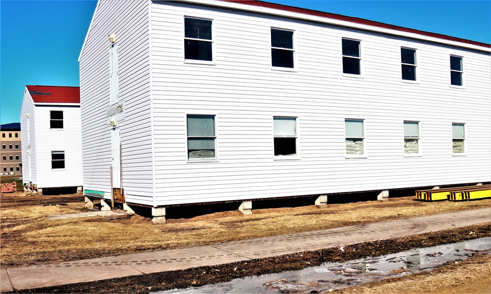 Contractors moving four World War II-era barracks buildings at Fort McCoy