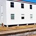 Contractors moving four World War II-era barracks buildings at Fort McCoy