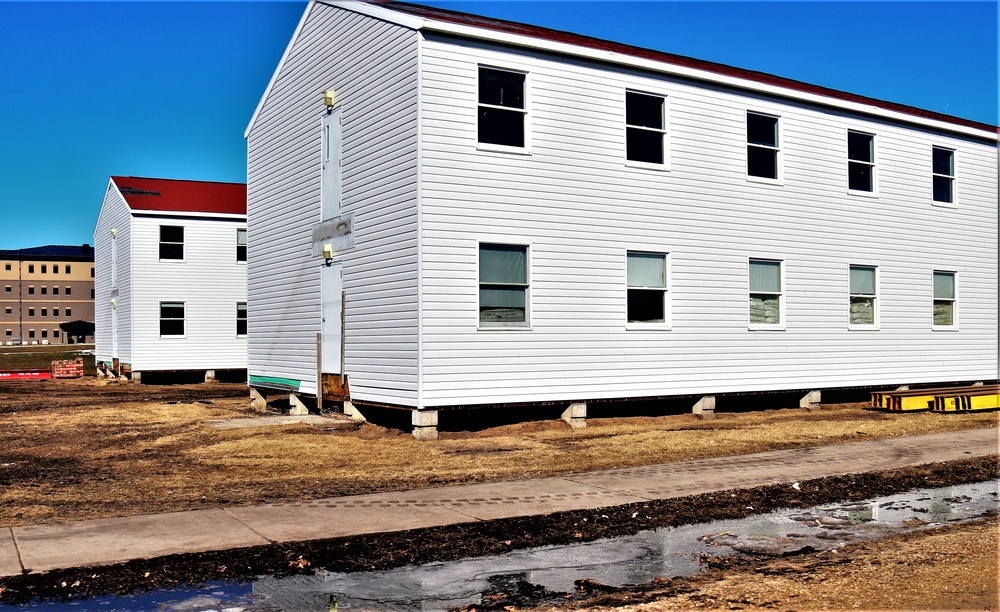 Contractors moving four World War II-era barracks buildings at Fort McCoy