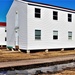 Contractors moving four World War II-era barracks buildings at Fort McCoy