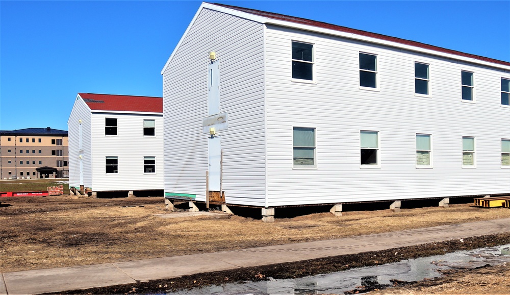 Contractors moving four World War II-era barracks buildings at Fort McCoy