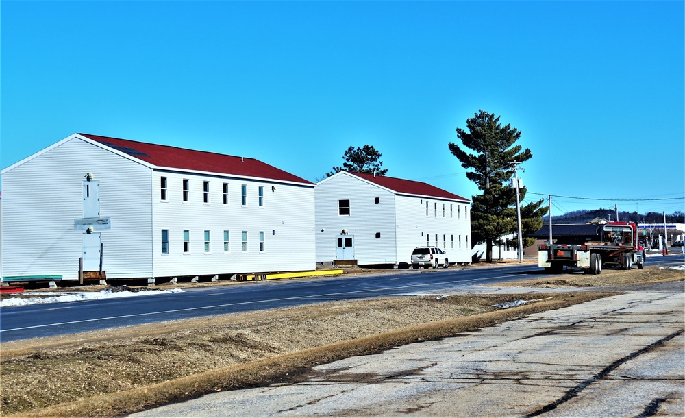 Contractors moving four World War II-era barracks buildings at Fort McCoy