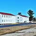 Contractors moving four World War II-era barracks buildings at Fort McCoy