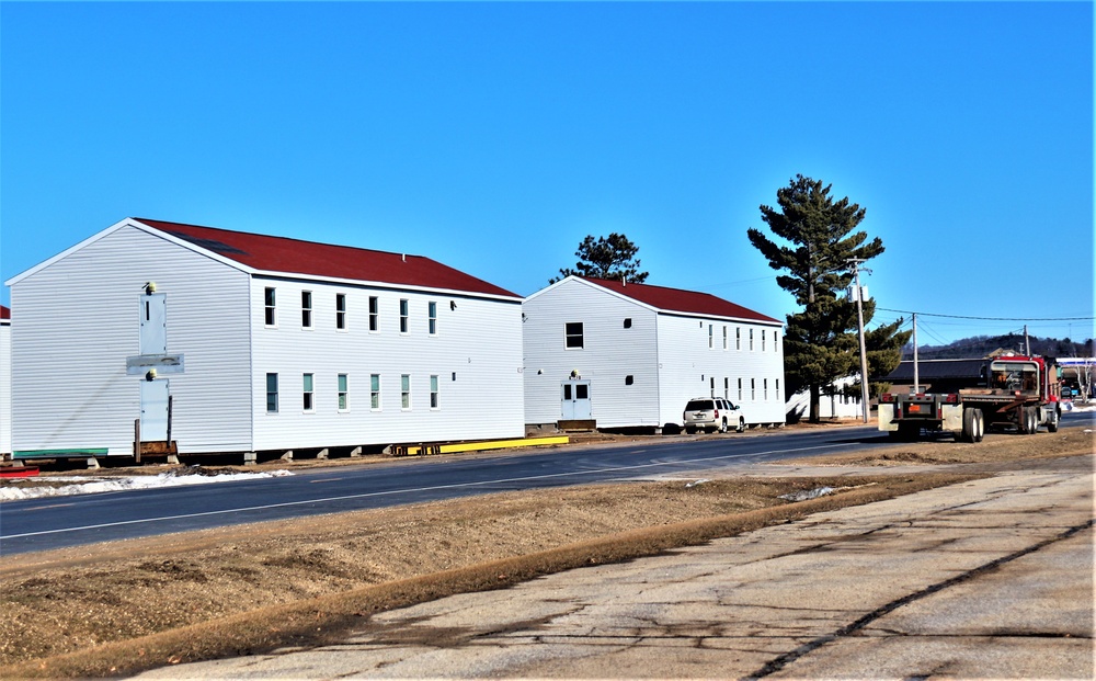 Contractors moving four World War II-era barracks buildings at Fort McCoy