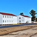 Contractors moving four World War II-era barracks buildings at Fort McCoy