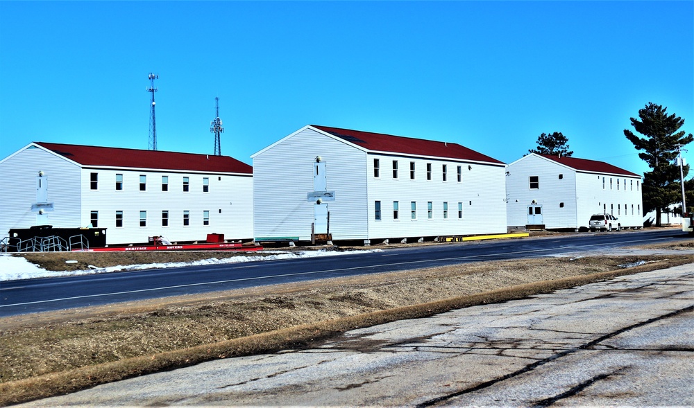 Contractors moving four World War II-era barracks buildings at Fort McCoy