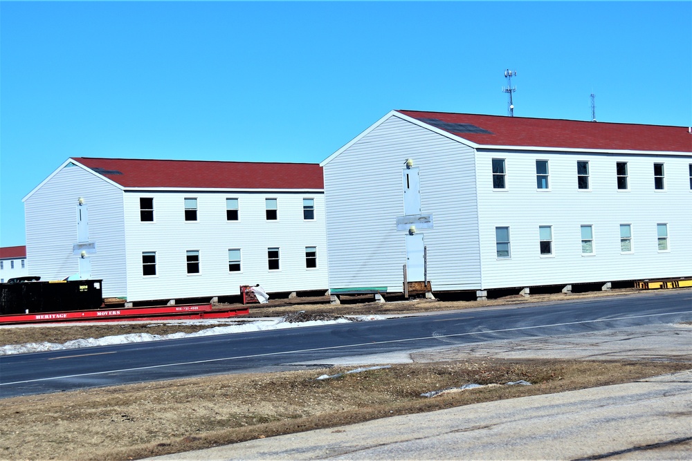 Contractors moving four World War II-era barracks buildings at Fort McCoy