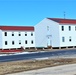 Contractors moving four World War II-era barracks buildings at Fort McCoy