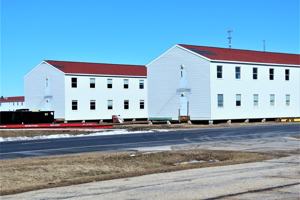 Contractors moving four World War II-era barracks buildings at Fort McCoy