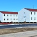 Contractors moving four World War II-era barracks buildings at Fort McCoy