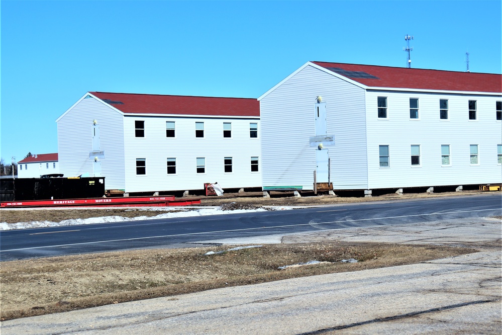 Contractors moving four World War II-era barracks buildings at Fort McCoy