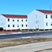 Contractors moving four World War II-era barracks buildings at Fort McCoy