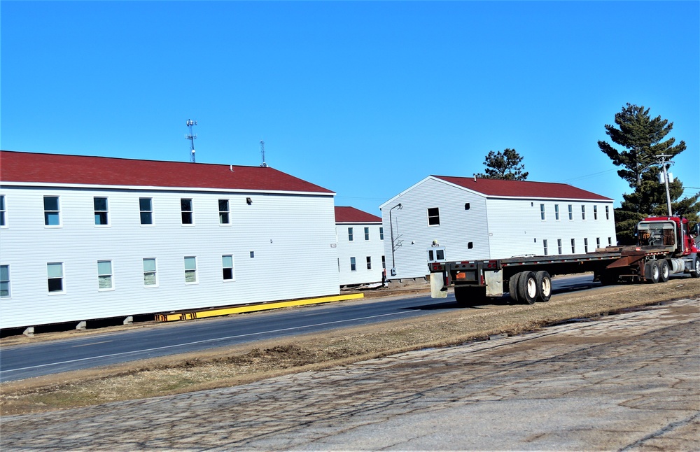 Contractors moving four World War II-era barracks buildings at Fort McCoy