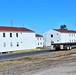 Contractors moving four World War II-era barracks buildings at Fort McCoy