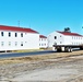 Contractors moving four World War II-era barracks buildings at Fort McCoy